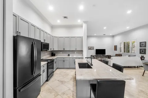 a living room with furniture and a book shelf