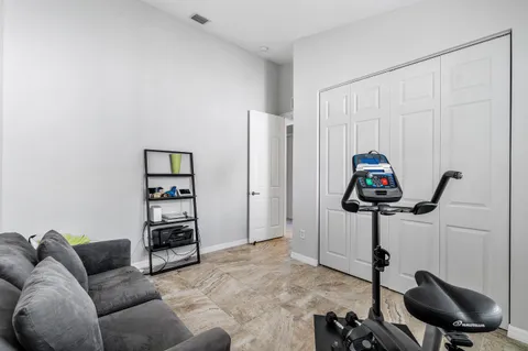an aerial view of residential houses with outdoor space and trees