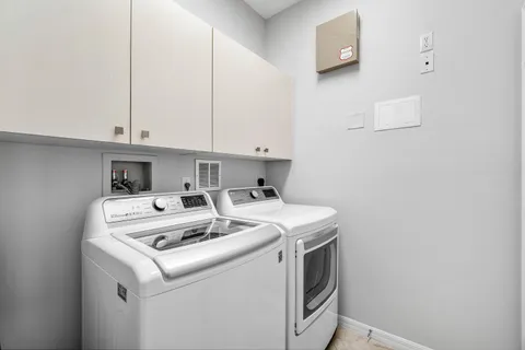 a view of a swimming pool with outdoor seating and plants