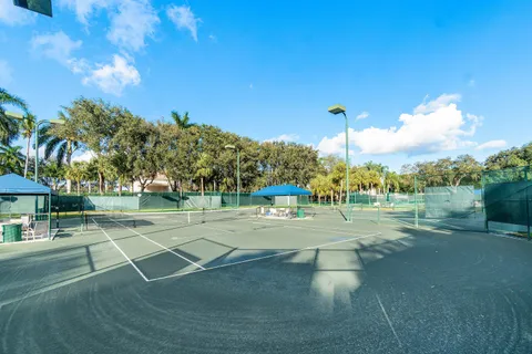 a living room with lots of furniture and view of kitchen