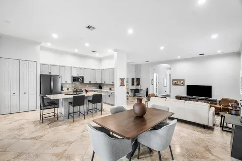 a kitchen with stainless steel appliances a stove a sink refrigerator and a cabinets