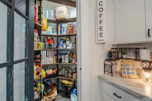 a view of a patio with wooden floor table and chairs
