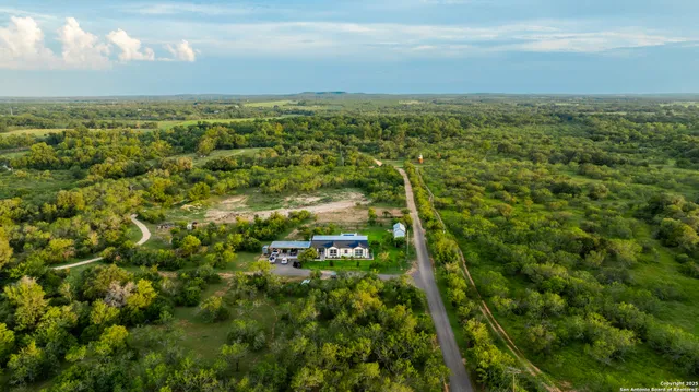 an aerial view of a house with a yard