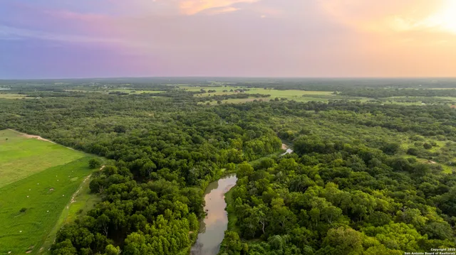 a view of a green field with an ocean view