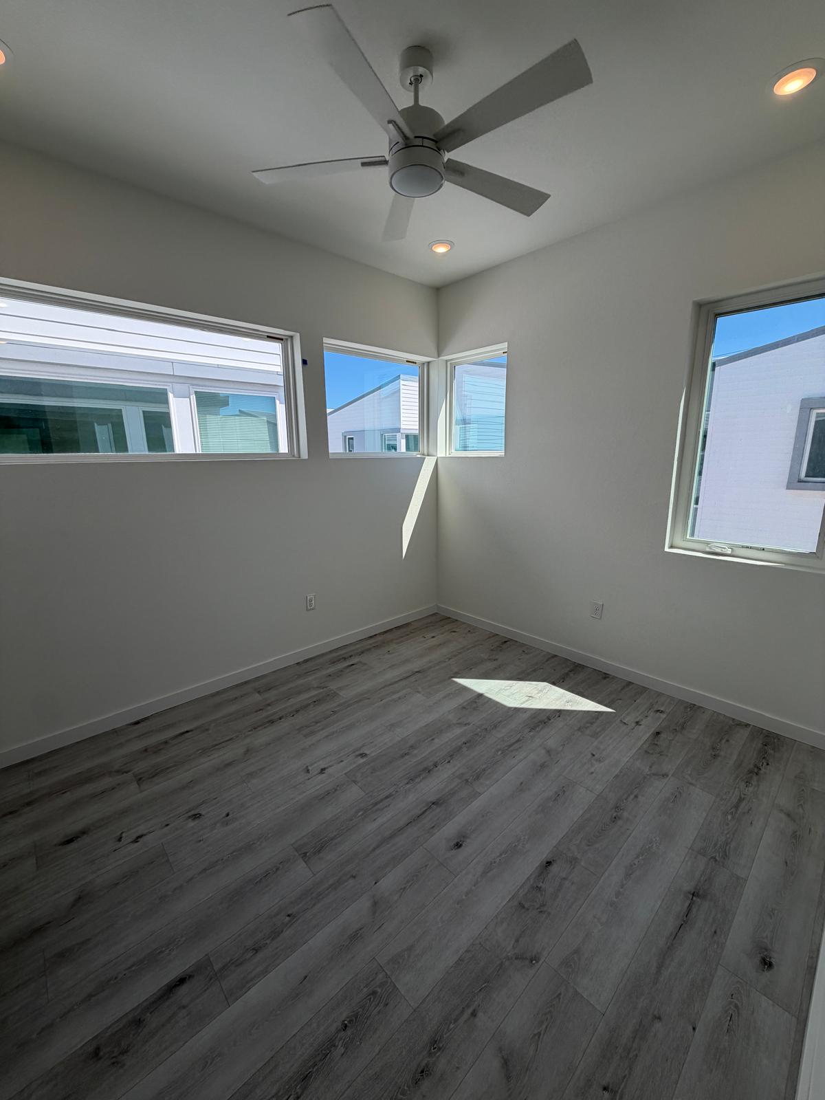 2000 Riverside Farms Road, Unit 12101 Austin, TX 78741 - Photo 27 of 33 Smooth wood-plank flooring and clean lines define this modern, sunlit bedroom space.