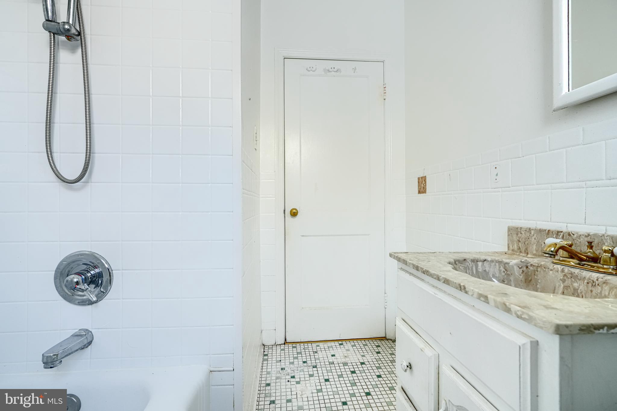 7839 Birmingham Avenue Baltimore, MD 21234 - Photo 15 of 24 a bathroom with a granite countertop sink a toilet and shower