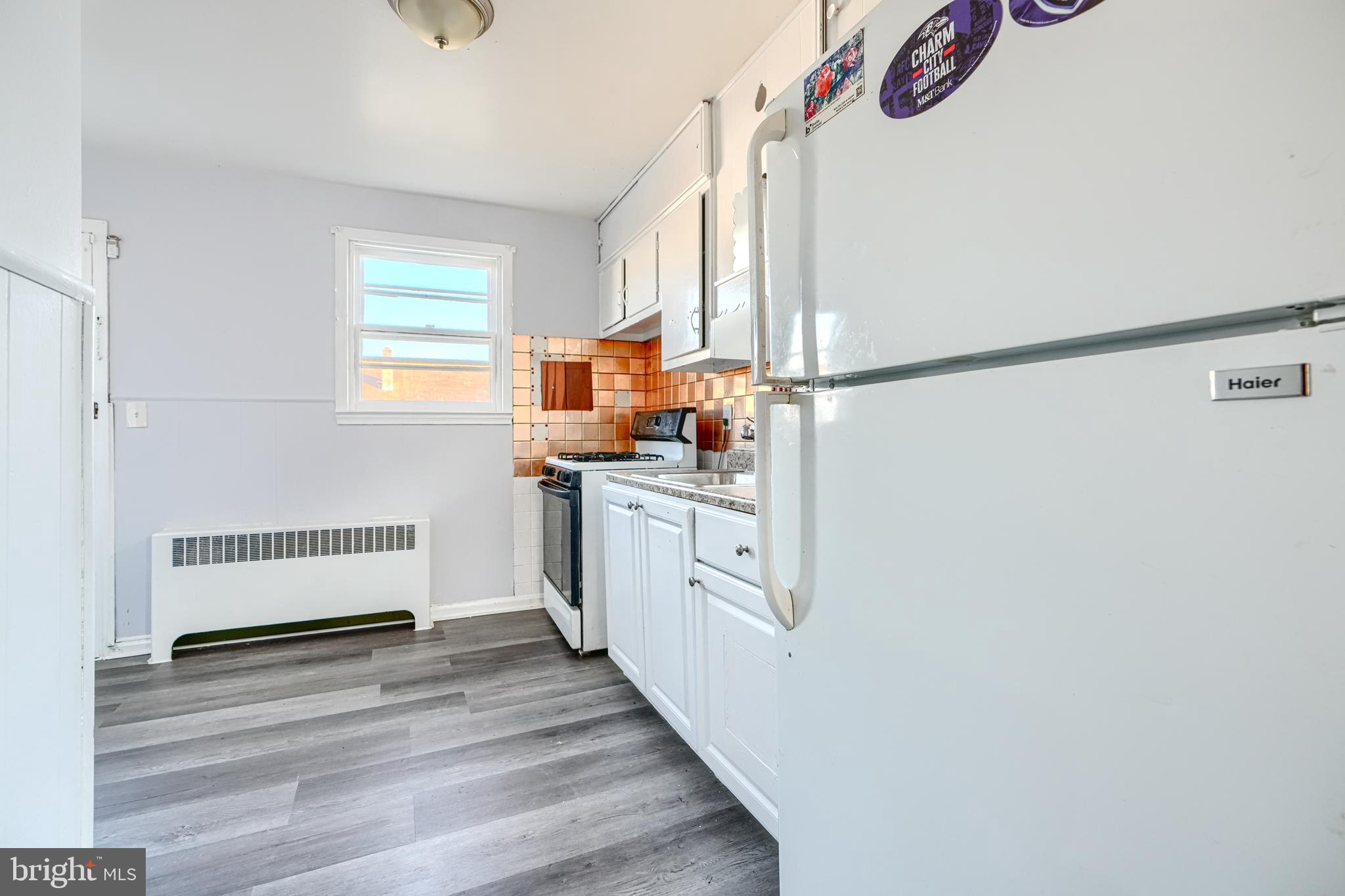 7839 Birmingham Avenue Baltimore, MD 21234 - Photo 8 of 24 a kitchen with granite countertop white cabinets and white appliances