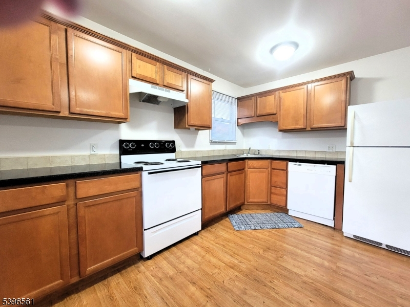 272 Us Highway, Unit C Andover, NJ 07821 - Photo 17 of 27 a kitchen with granite countertop wooden cabinets and white appliances