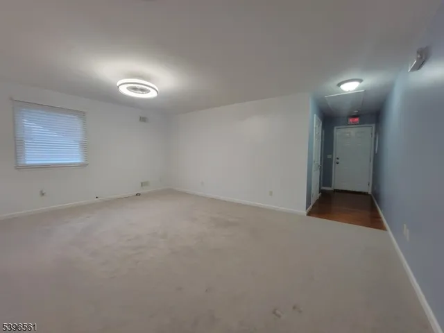 a view of hallway with wooden floor