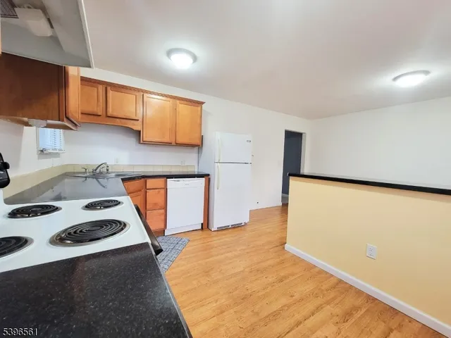 a kitchen with a stove a sink and a refrigerator