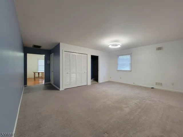 a view of an empty room and closet area