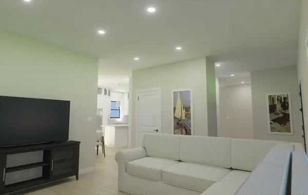 a living room with furniture and a view of kitchen