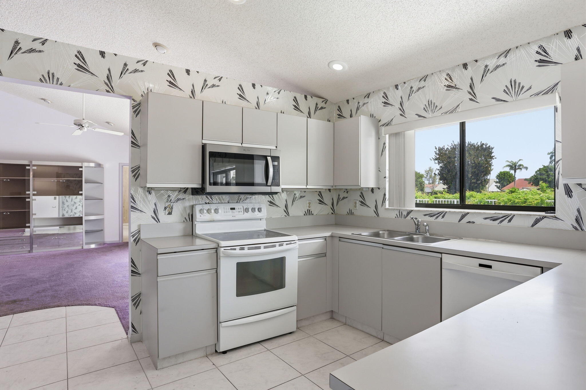 9476 El Clair Ranch Road Boynton Beach, FL 33437 - Photo 13 of 29 a kitchen with a sink stove and microwave