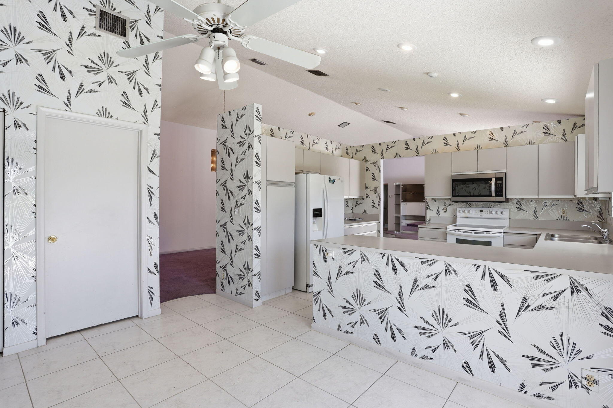 9476 El Clair Ranch Road Boynton Beach, FL 33437 - Photo 16 of 29 a view of kitchen with stainless steel appliances kitchen island granite countertop a refrigerator and a sink