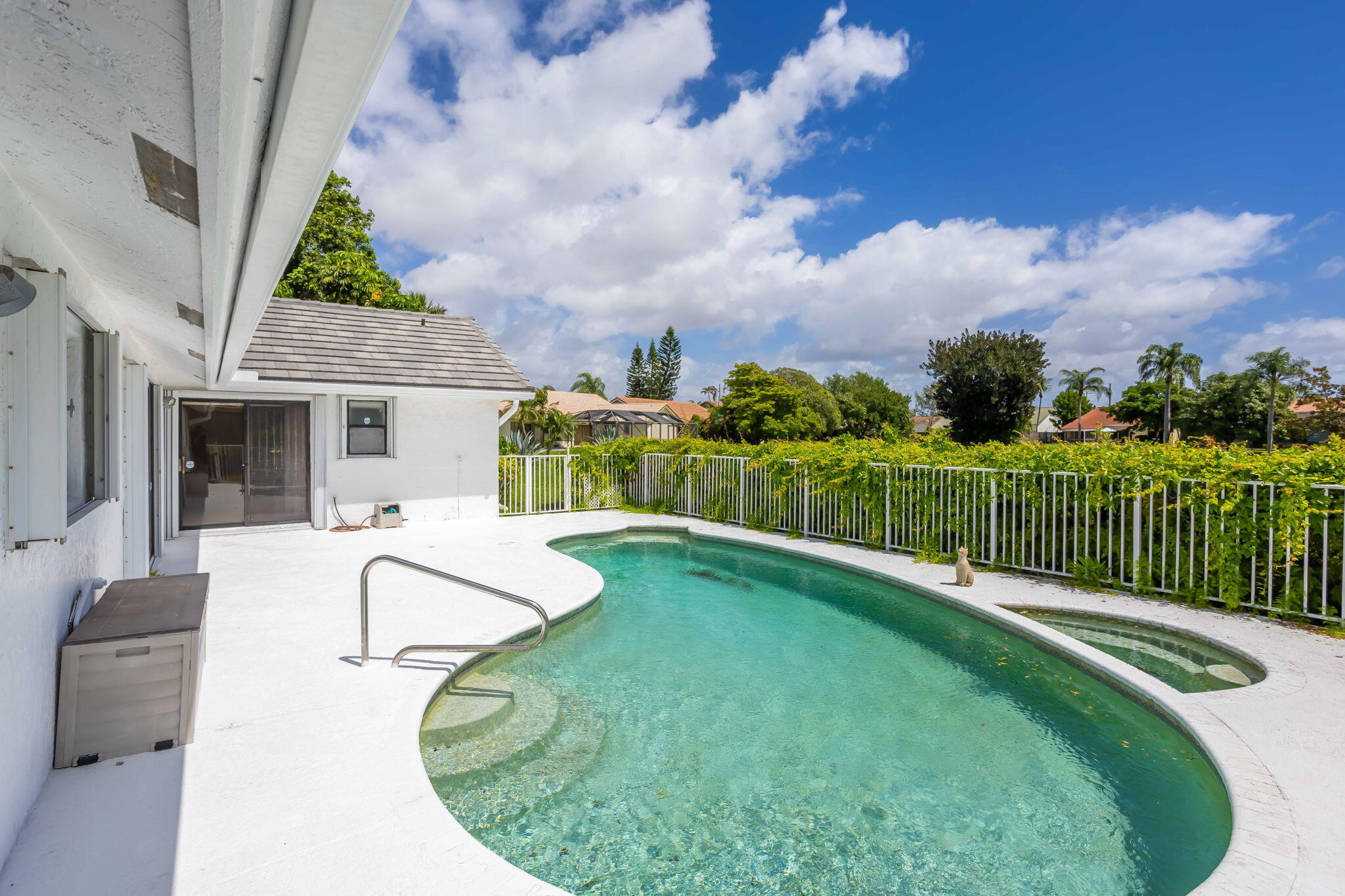 9476 El Clair Ranch Road Boynton Beach, FL 33437 - Photo 17 of 29 a swimming pool with barbeque oven in front of it