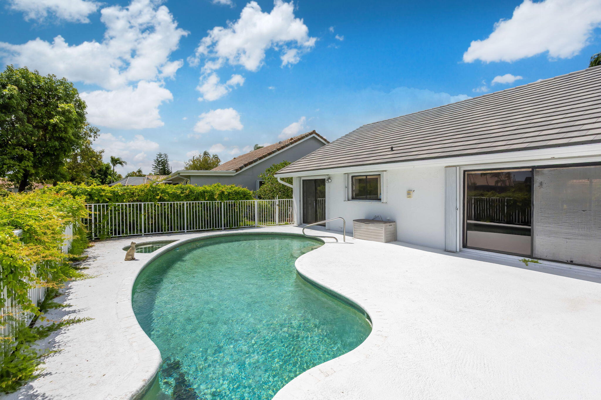 9476 El Clair Ranch Road Boynton Beach, FL 33437 - Photo 2 of 29 a front view of a house with garden