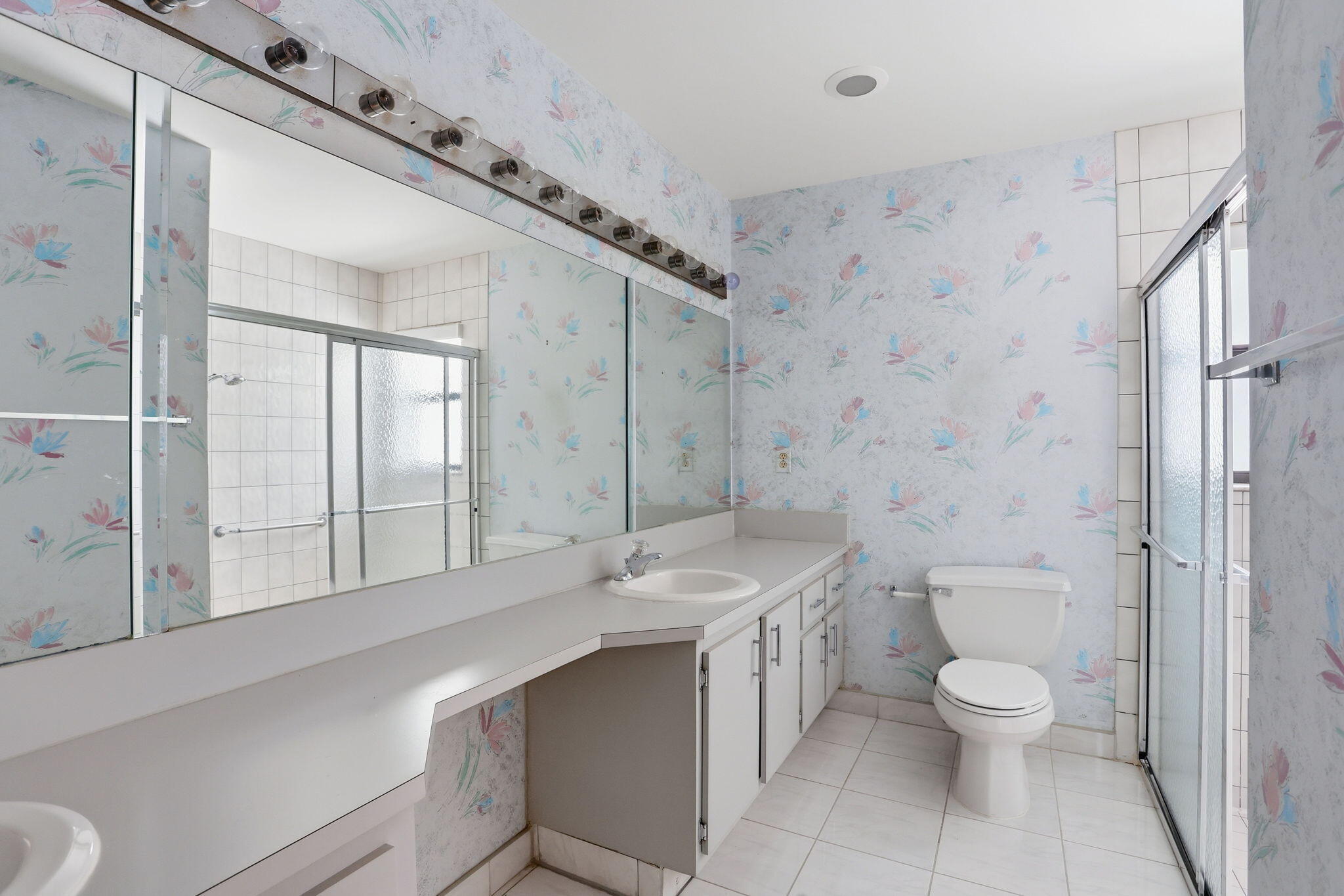 9476 El Clair Ranch Road Boynton Beach, FL 33437 - Photo 24 of 29 a bathroom with a granite countertop toilet a sink and a shower