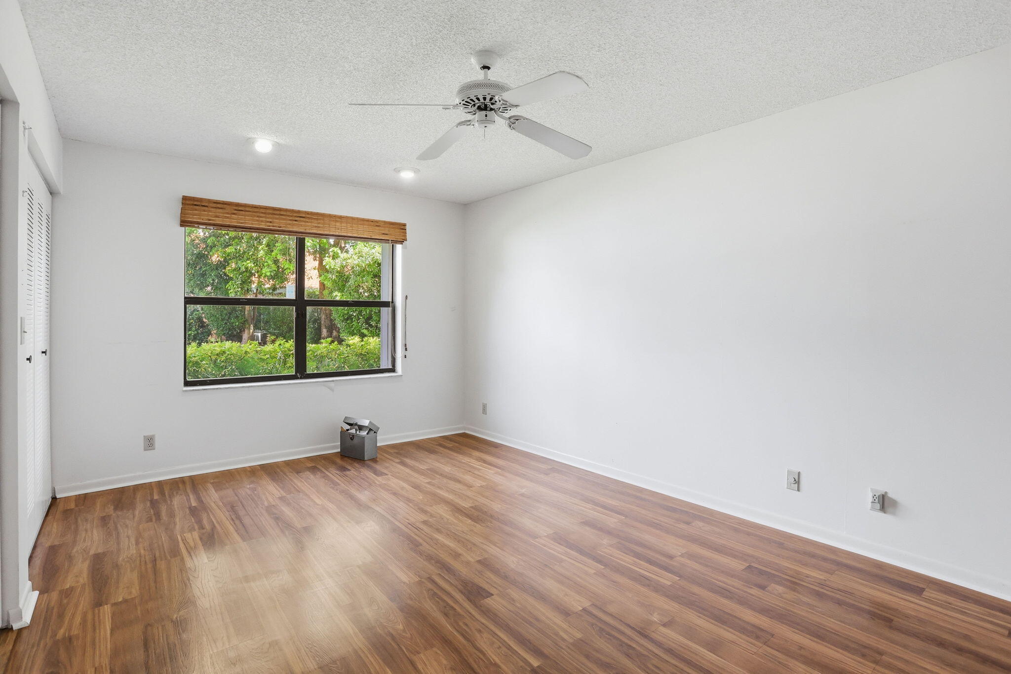 9476 El Clair Ranch Road Boynton Beach, FL 33437 - Photo 28 of 29 wooden floor in an empty room with a window