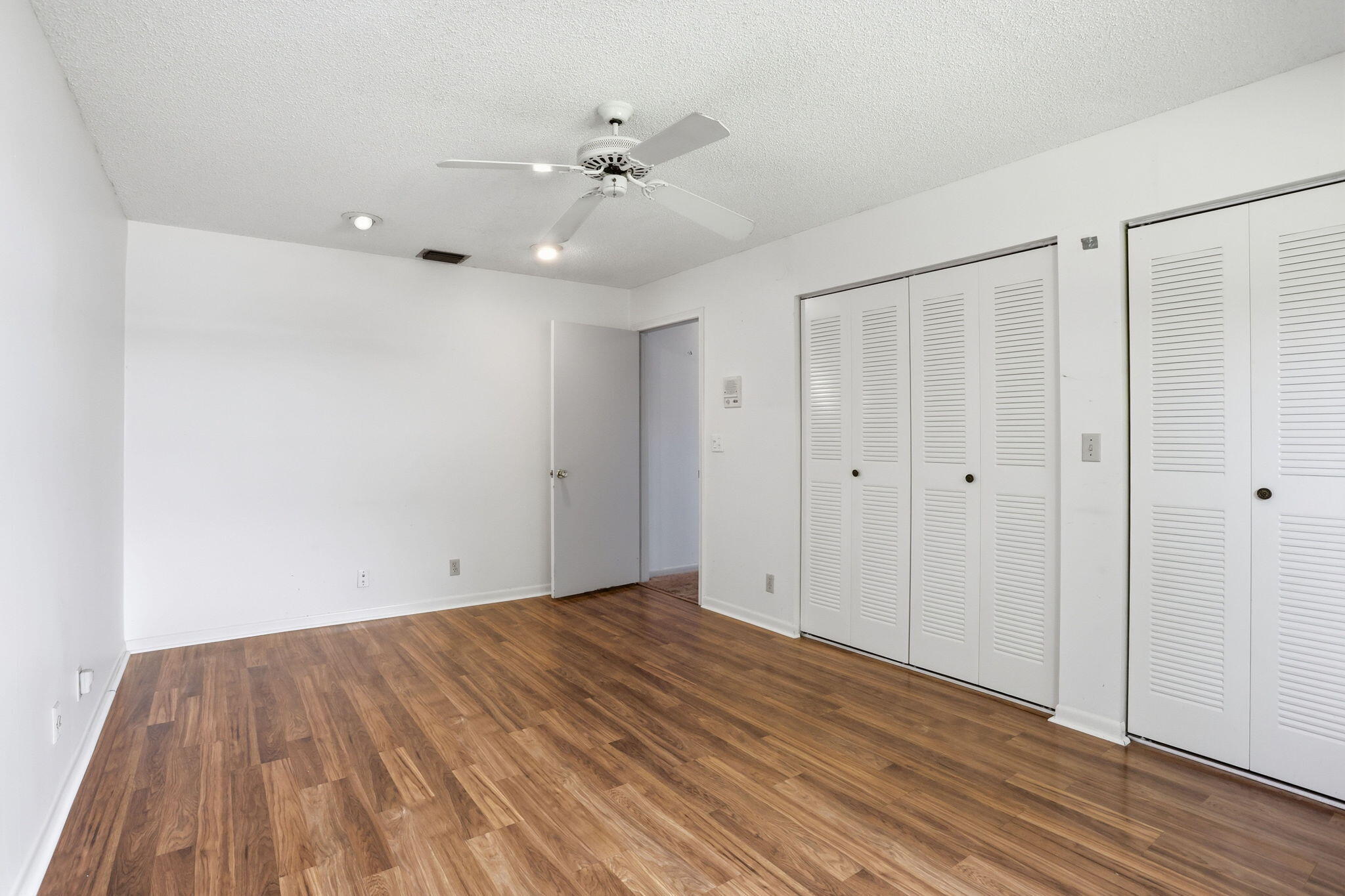 9476 El Clair Ranch Road Boynton Beach, FL 33437 - Photo 29 of 29 a view of an empty room with wooden floor