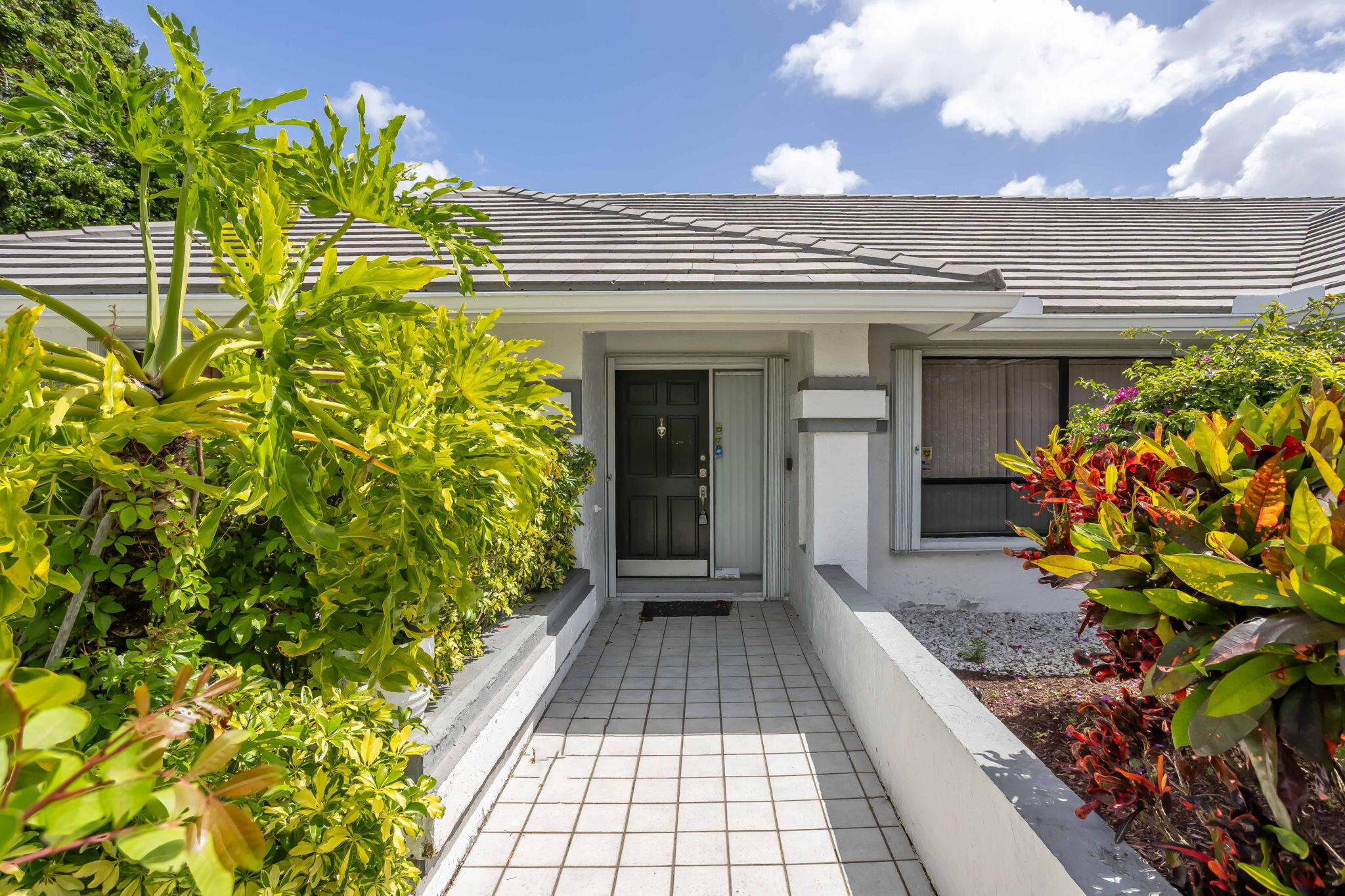 9476 El Clair Ranch Road Boynton Beach, FL 33437 - Photo 4 of 29 a view of a pathway of the house front of a house
