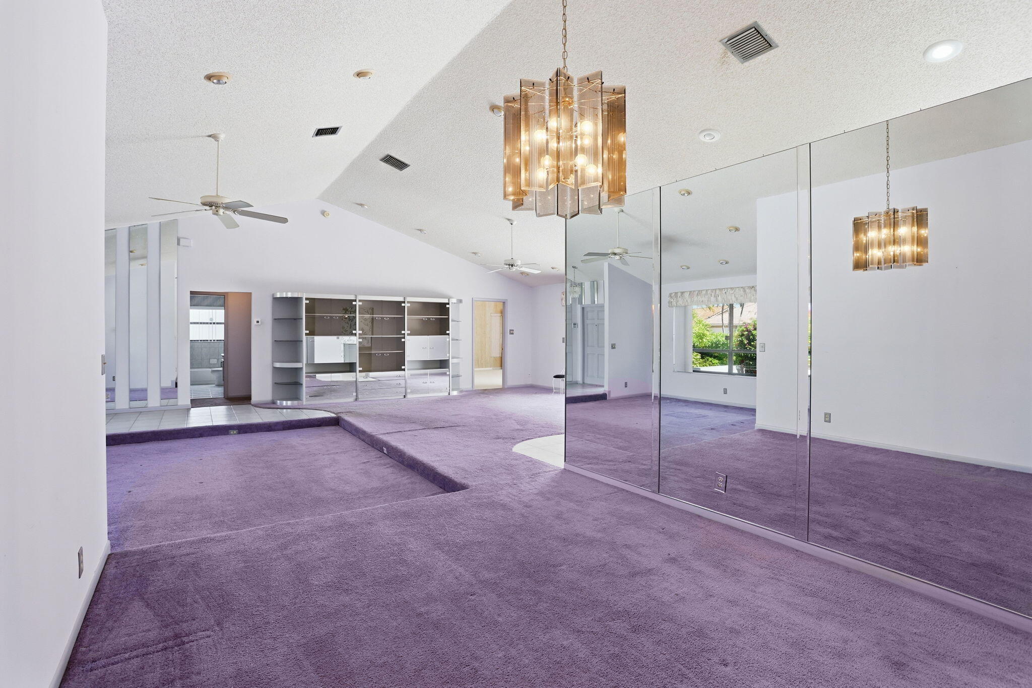 9476 El Clair Ranch Road Boynton Beach, FL 33437 - Photo 8 of 29 a view of a hallway with chandelier and glass door