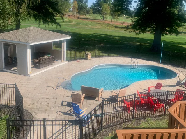 a view of a patio with a table and chairs under an umbrella