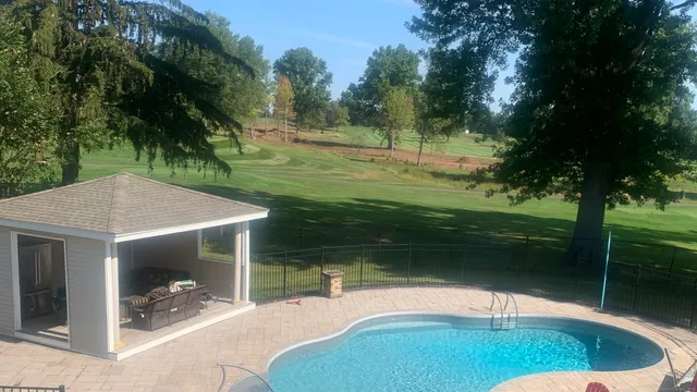 a swimming pool with outdoor seating and yard