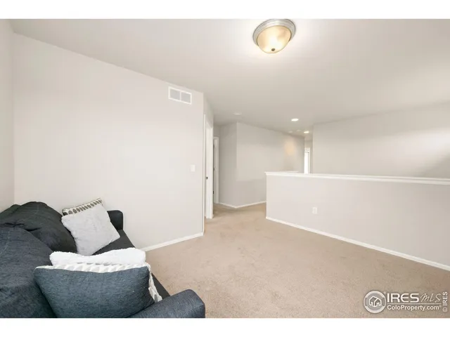 a spacious bedroom with a bed and a dresser