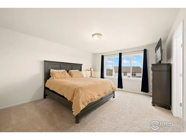 a en suite bathroom with a tub double vanity and window