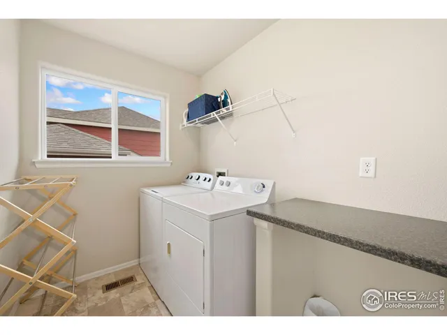 a bathroom with a granite countertop sink toilet mirror and bathtub