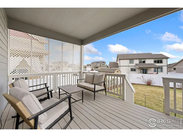 a view of a patio with table and chairs with wooden floor