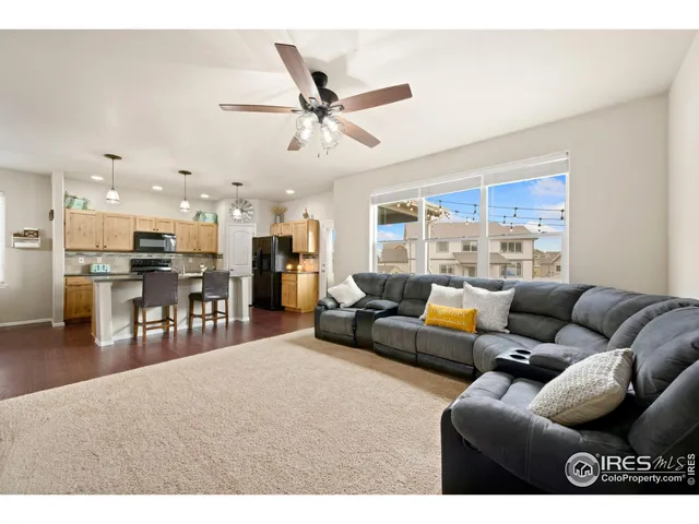 a living room with furniture and kitchen view