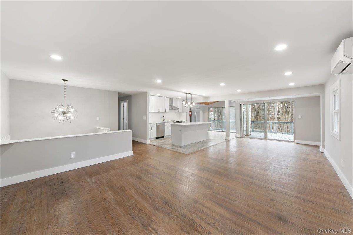 96 Fairmont Road Mahopac, NY 10541 - Photo 5 of 34 Open-concept living space featuring wood-finish flooring, recessed lighting, and a modern kitchen with a central island