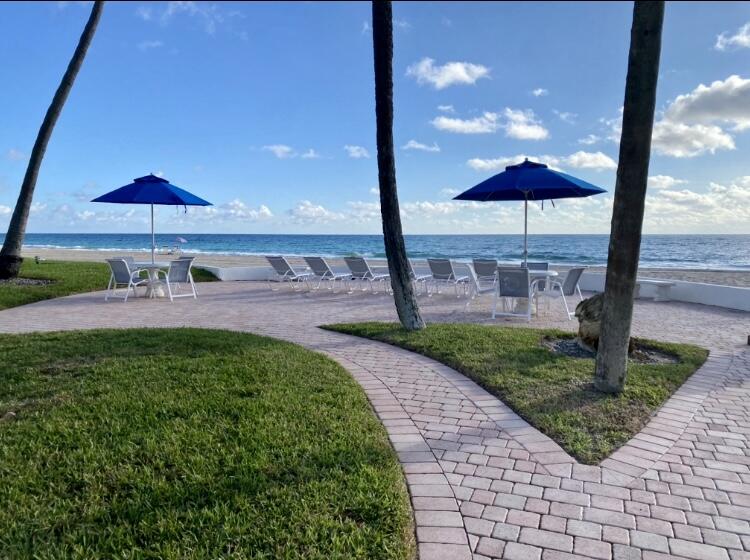 1530 South Ocean Boulevard, Unit 303 Lauderdale-by-the-Sea, FL 33062 - Photo 11 of 27 a view of a backyard with under an umbrella