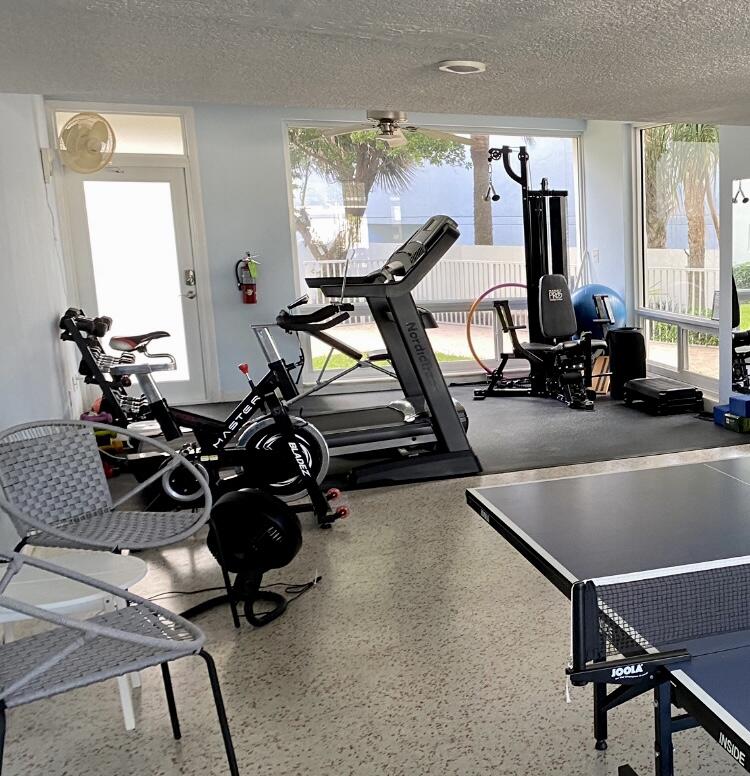 1530 South Ocean Boulevard, Unit 303 Lauderdale-by-the-Sea, FL 33062 - Photo 13 of 27 a room with gym equipment and windows