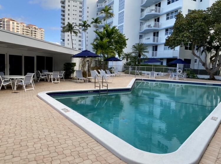 1530 South Ocean Boulevard, Unit 303 Lauderdale-by-the-Sea, FL 33062 - Photo 16 of 27 a view of a swimming pool with a patio