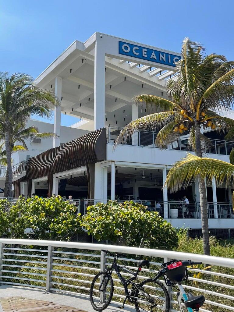1530 South Ocean Boulevard, Unit 303 Lauderdale-by-the-Sea, FL 33062 - Photo 20 of 27 a view of a patio with chairs and a flower plants