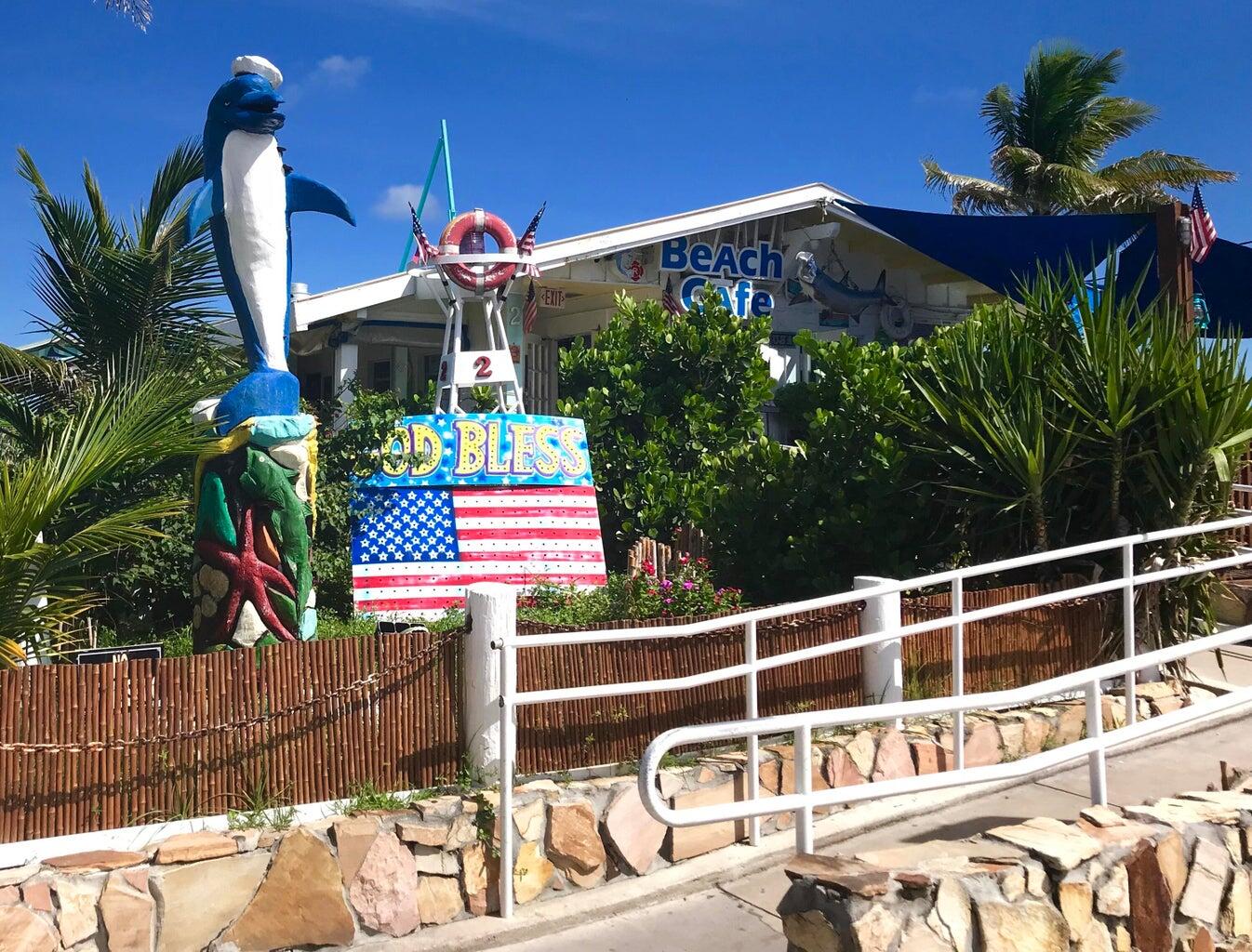 1530 South Ocean Boulevard, Unit 303 Lauderdale-by-the-Sea, FL 33062 - Photo 23 of 27 a front view of a house with a yard