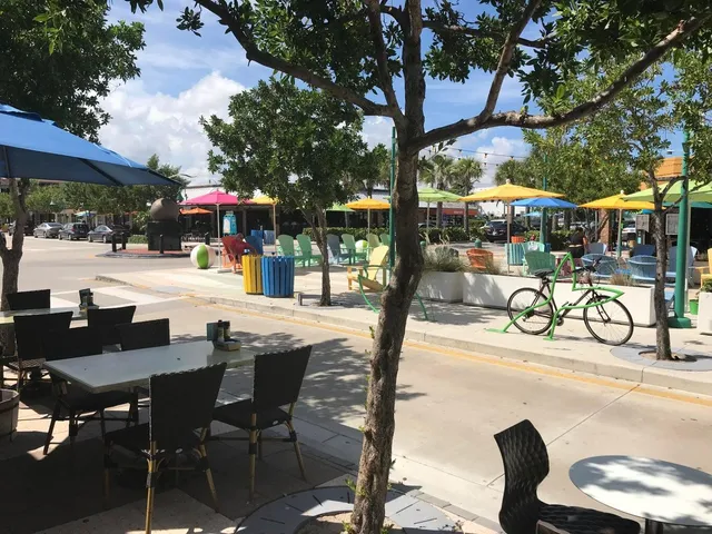 a view of a patio with a table and chairs under an umbrella
