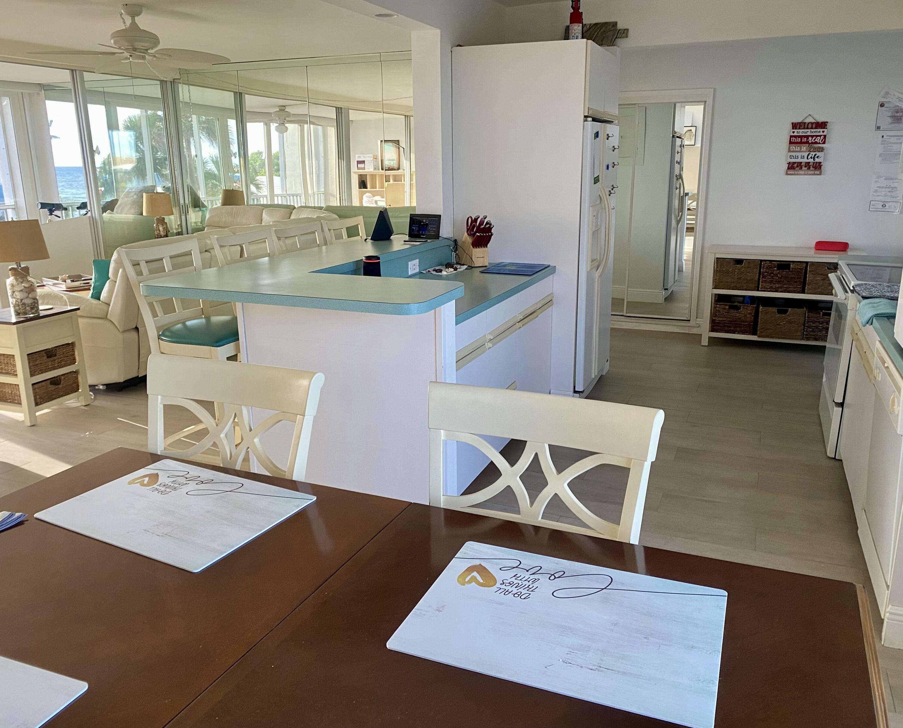 1530 South Ocean Boulevard, Unit 303 Lauderdale-by-the-Sea, FL 33062 - Photo 6 of 27 a living room with stainless steel appliances kitchen island granite countertop furniture and a wooden floor