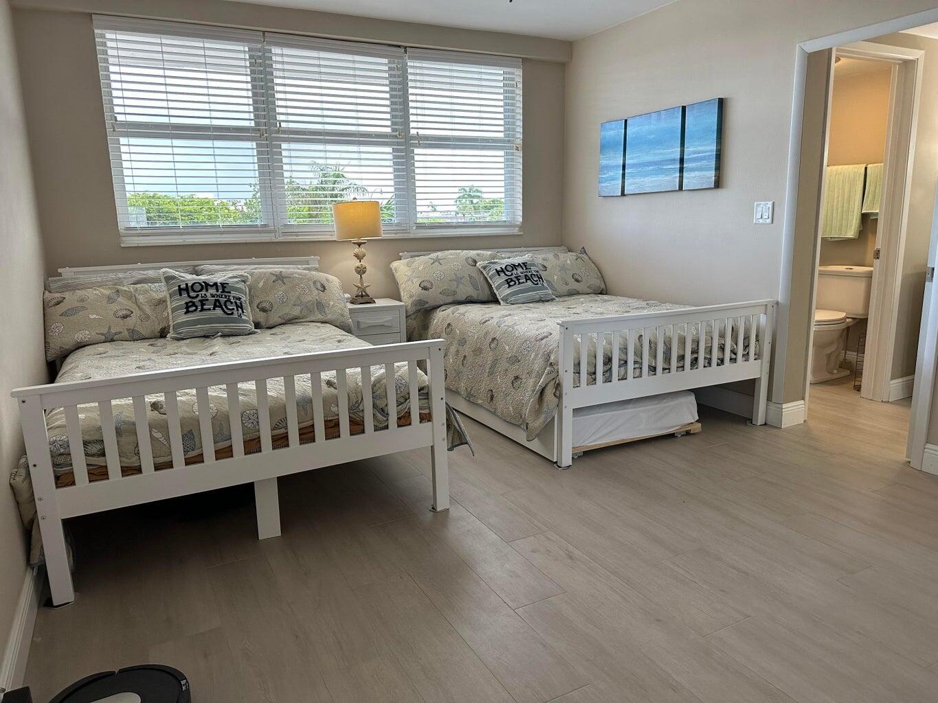 1530 South Ocean Boulevard, Unit 303 Lauderdale-by-the-Sea, FL 33062 - Photo 9 of 27 a bedroom with two beds and a window
