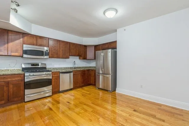 a kitchen with stainless steel appliances cabinets a sink and a stove