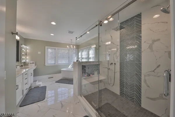 a bathroom with a glass shower door and a sink