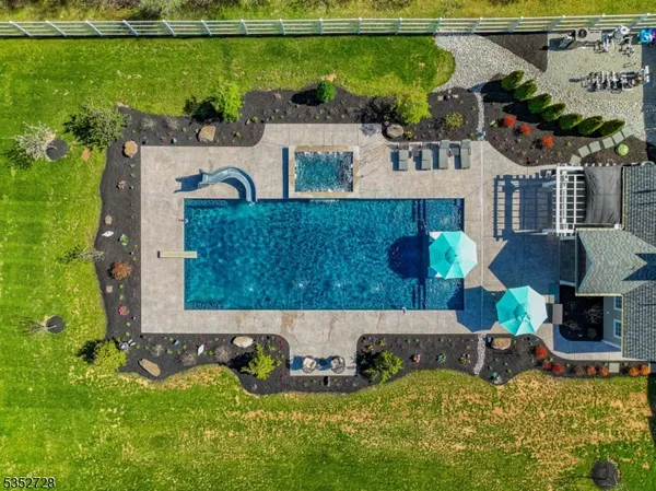 an aerial view of a house with yard swimming pool and outdoor seating