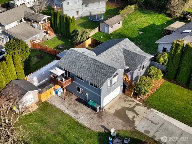 an aerial view of a house with garden space and street view
