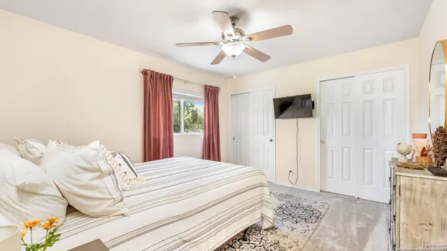 a bedroom with a large bed and a window