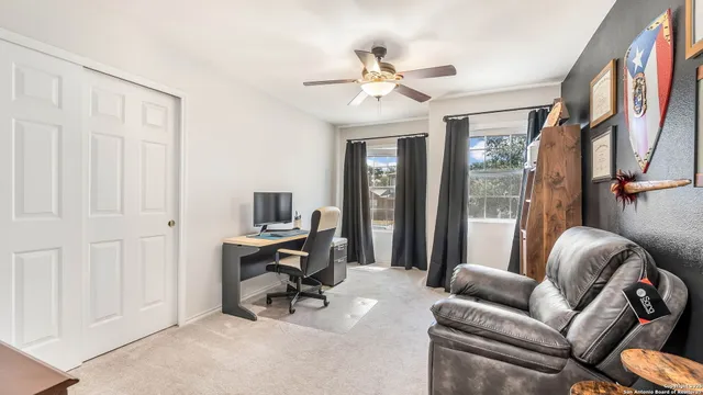 a view of a livingroom with workspace and a couch