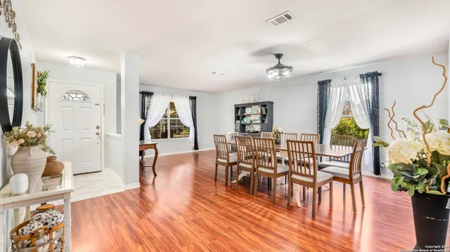 a living room with furniture dining table and a flat screen tv