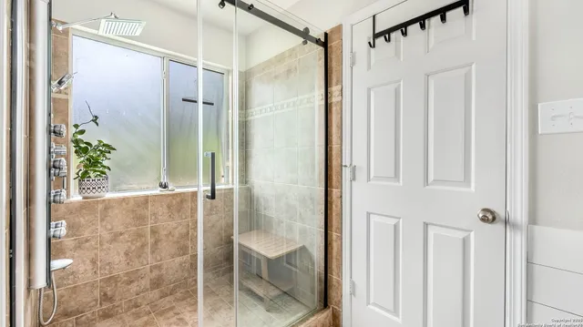 a bathroom with a glass shower door