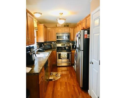 217 Reeves Street Fall River, MA 02721 - Photo 3 of 12 a kitchen with refrigerator and cabinets